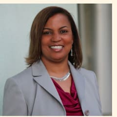 Ellen Ross, Mini Money creator and attorney, in a grey blazer.