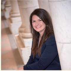 Liz Carter, youth coach and leader, beside a marble column.