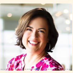 Timeri Tolnay, Executive Director of GALS Denver, in a pink patterned top.